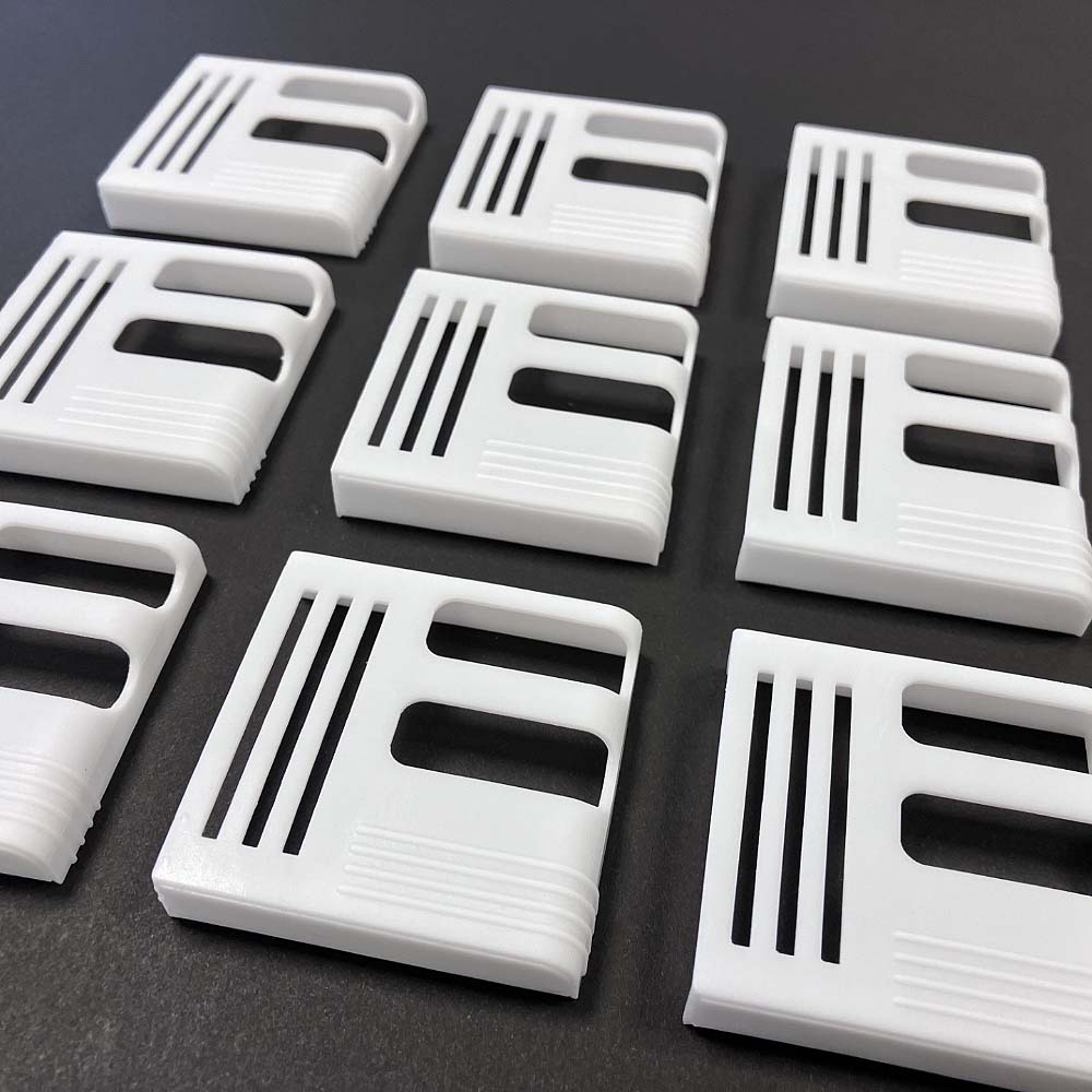Image of a customer receiving their 3D printed medical shrouds, showcasing the finished prototypes delivered and ready for use.